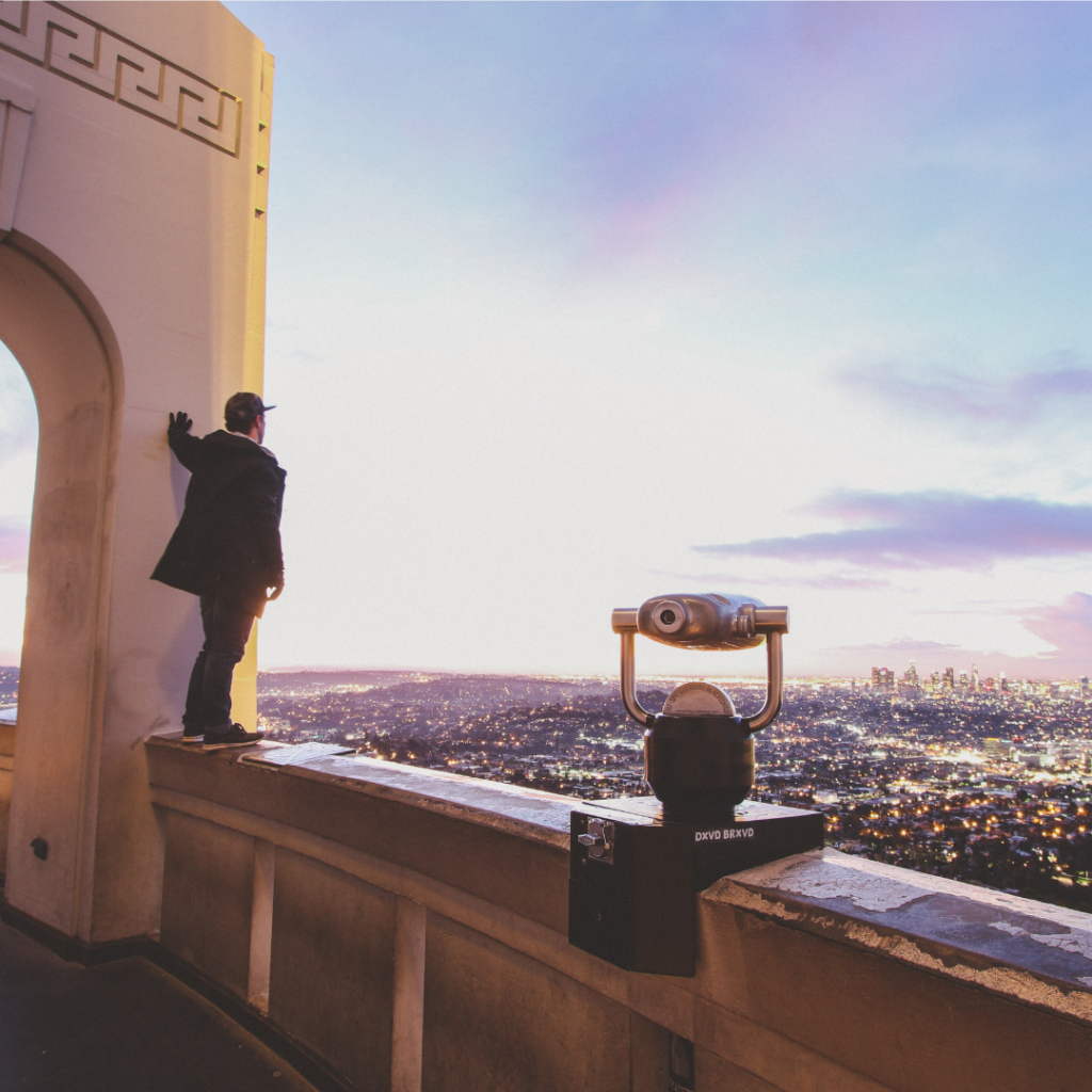 Person standing on rooftop looking at the view