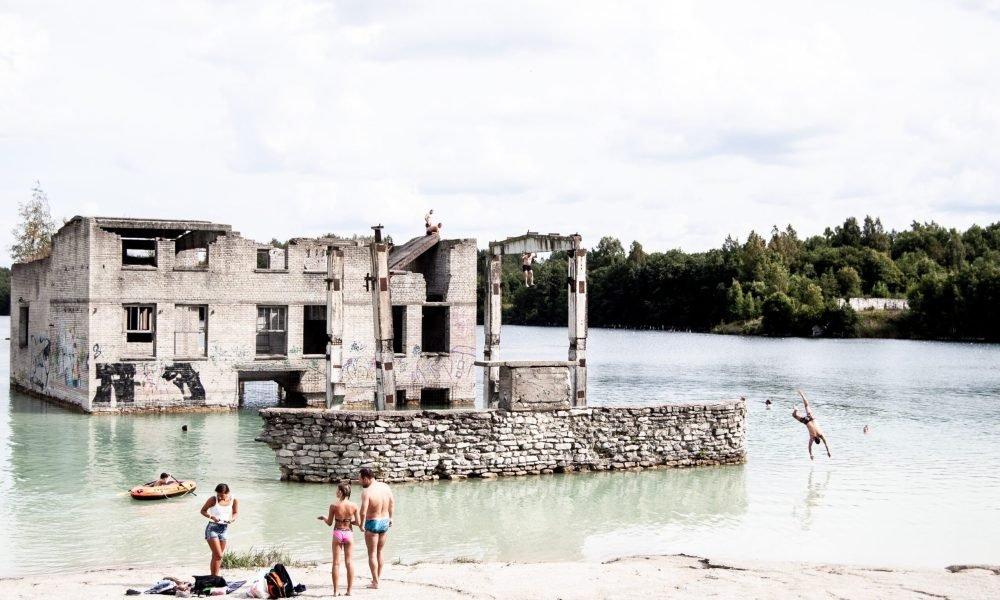 remote-workers-taking-a-break-swimming-in-a-lake-near-an-old-prison-in-tallinn