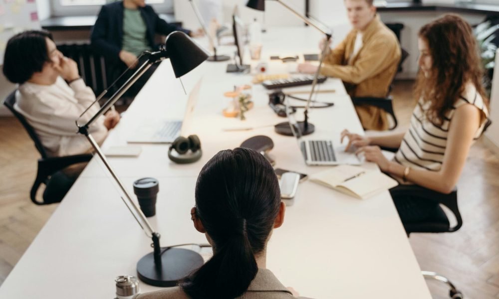 A group of workers in a co-working space, shows remote work