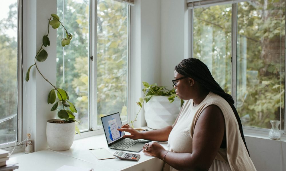 person working on laptop by the window